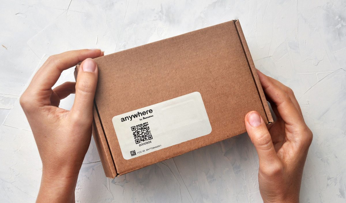The Bluetooth label applied to the outside of a cardboard parcel, showing
                  the QR code and serial number.